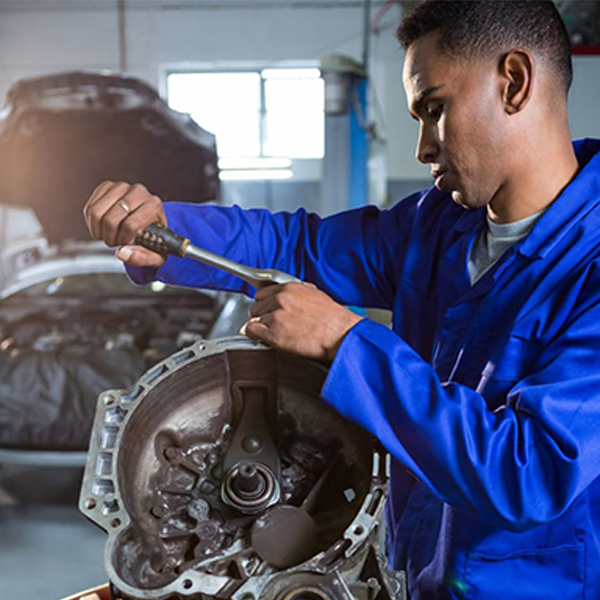 Mechanic repairing engine part with ratchet Mechanic repairing engine part with ratchet